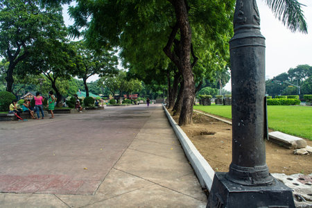 Rizal Park, Manila, Philippines July 2, 2014: A pathway with lots of trees at the Rizal Park along Taft Ave., Manila, Philippinesのeditorial素材