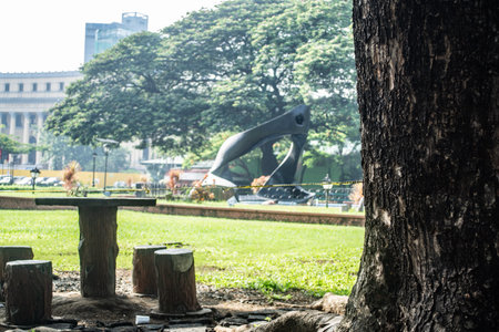 Rizal Park, Manila, Philippines July 2, 2014: Table and chairs under a tree at the Rizal Park along Taft Ave., Manila, Philippinesのeditorial素材