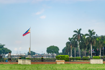 Rizal Park, Manila, Philippines July 2, 2014: The Philippine flag at the background of the grassy field at the Rizal Park in Manila, Philippinesのeditorial素材