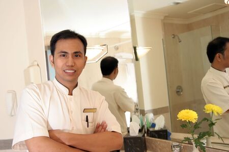 husekeeping or room boy in bath room hotelの写真素材
