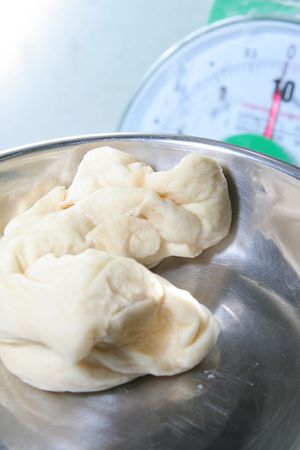pastry dough on weighing scaleの写真素材
