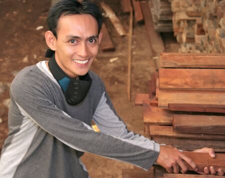 Man at Lumber or timber with mask on his neckの写真素材