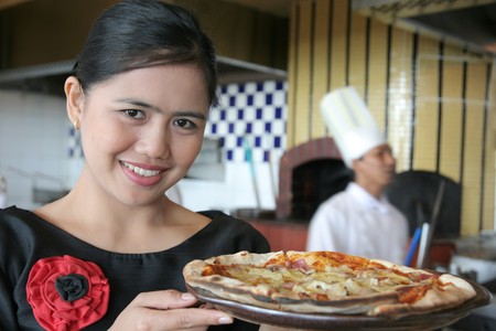 waitress with pizzaの写真素材