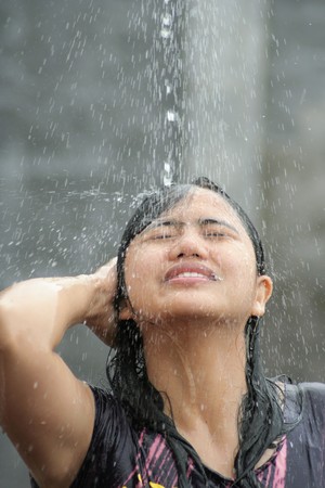 Portrait Of Woman Shower Iin Water Splash Outdoorの写真素材