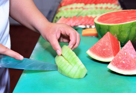 slicing fruit for buffetの写真素材