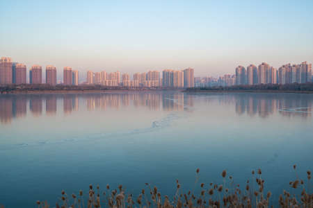 Reflection of buildings in Tianjin Meijiang Lake in winterの写真素材