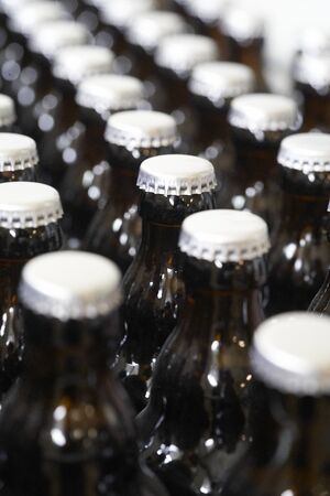 A close up of crown caps on beer bottlesの写真素材