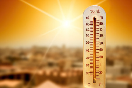 A thermometer with the sun in the background. Generative AI. Thermometer showing extreme temperatures. Thermometer showing extreme temperatures.の素材