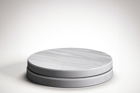 A white marble plate sitting on top of a table. Empty podium mockup for beauty product.の素材