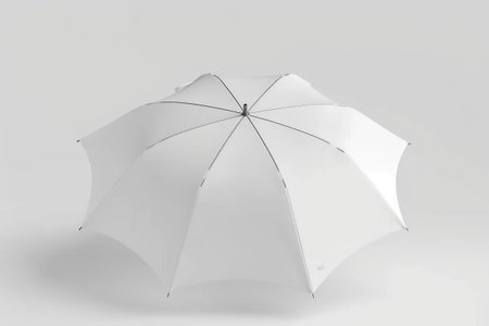 A pristine white umbrella gracefully stands on a white background, exuding an ethereal and minimalist elegance. Blank mockup, copy-space.の素材