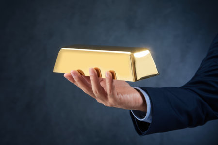 Businessman Holding Gold Bar Against Dark Background, Symbol of Wealth, Investment, and Financial Security.の写真素材