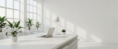 Modern minimalist office setup featuring a laptop, desk lamp, and small potted plants on a white desk. Large windows allow natural light to fill the space.の素材