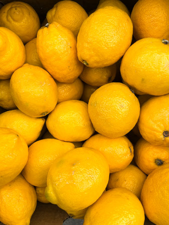 Fresh lemons on a market stall, closeup of photo.