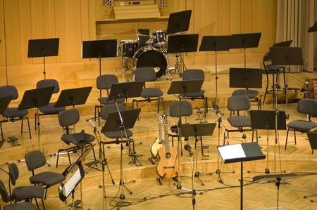 	Empty seats and some instruments in music hall awaiting orchestra to come on the stageの写真素材