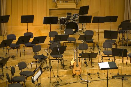  	Empty seats and some instruments in music hall awaiting orchestra to come on the stageの写真素材