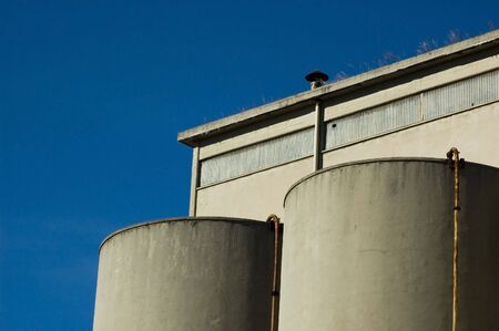 Abandoned industrial building with blue sky in the backgroundの写真素材