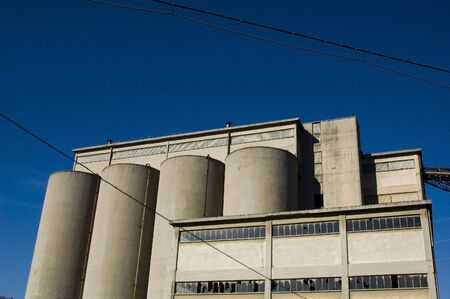 Abandoned industrial building with blue sky in the backgroundの写真素材