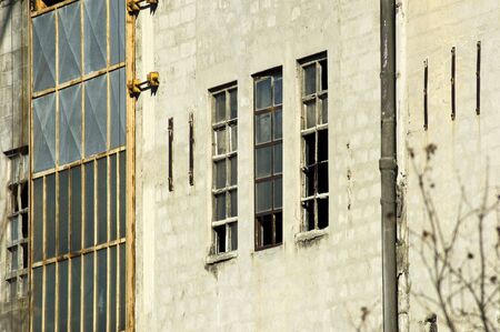 Abandoned industrial building closeup with some broken windowsの写真素材