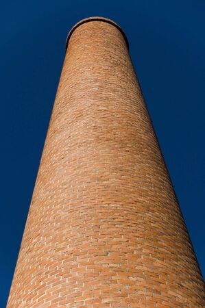 Industrial chimney and blue sky in the backgroundの写真素材