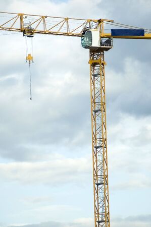Close view of a construction lift with a blue cloudy sky in the backgroundの写真素材