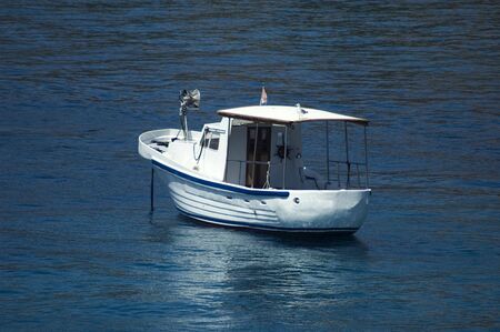 Single white boat on the sea surfaceの写真素材
