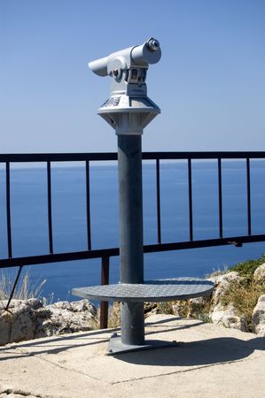Spyglass on a view point on the hill next to the seasideの写真素材