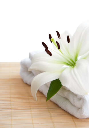 white lily and  towel  on a white backgroundの写真素材