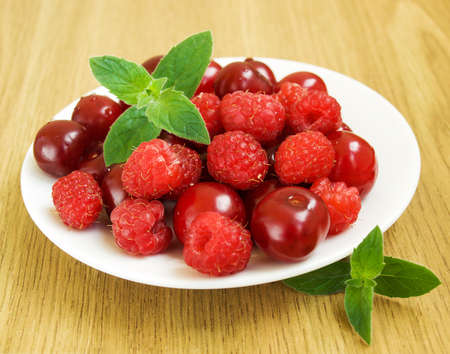 Plate with Summer berries and mint on the table