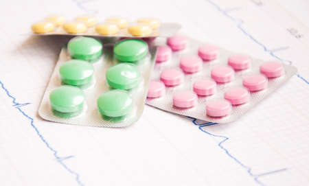 Close up of a EKG with pills sitting on top of itの写真素材
