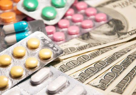 Costs for health care, tablets and dollar banknotesの写真素材