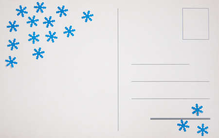 Backside of a blank vintage postcard with snowflakes decorationの写真素材