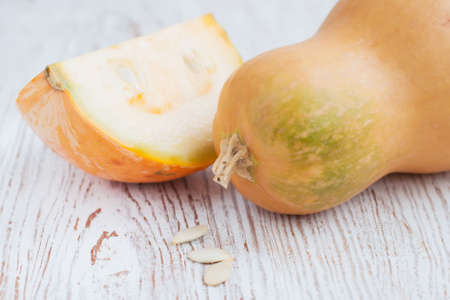 Pumpkins, whole and cut on a  wood background
