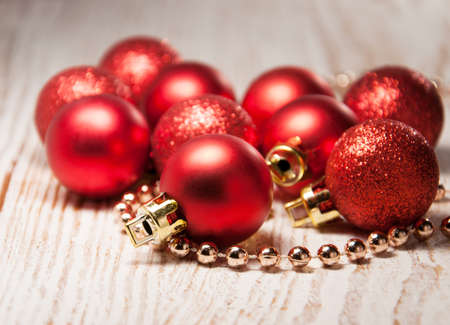 red christmas baubles on rustic wooden backgroundの写真素材