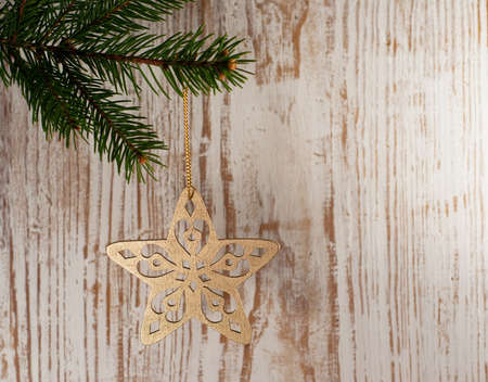 Beautiful golden star haging in a Christmas treeの写真素材