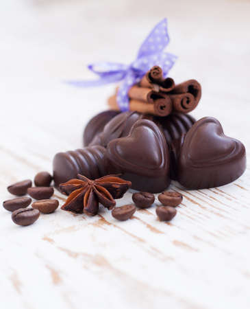 Chocolate with cinnamon, anise  on a wood backgroundの写真素材