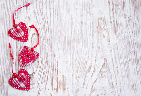  heart shapes an old wooden background の写真素材