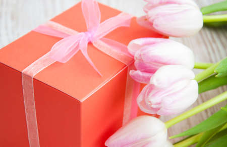 bouquet of pink tulips, gift box on a tableの写真素材