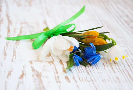 snowdrop and crocus spring flowers on a tableの写真素材