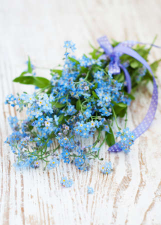 Bunch of forget-me-nots flowers on a wooden backgroundの写真素材