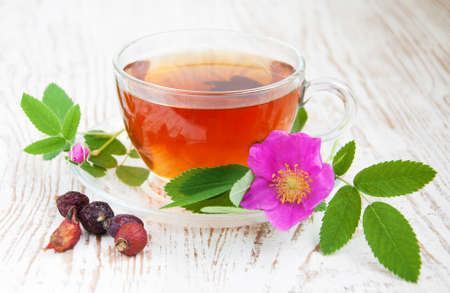 Cup of rose hip tea on a wooden backgroundの写真素材