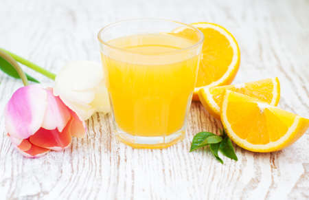 Orange juice with sliced orange on the wooden backgroundの写真素材