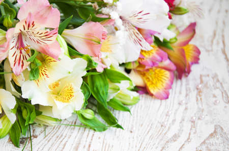 bouquet of alstroemeria flowers on a wooden backgroundの写真素材