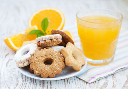 Orange juice and cookies on a wooden backgroundの写真素材