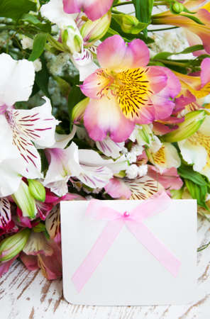 alstroemeria flowers with a white card for a messageの写真素材