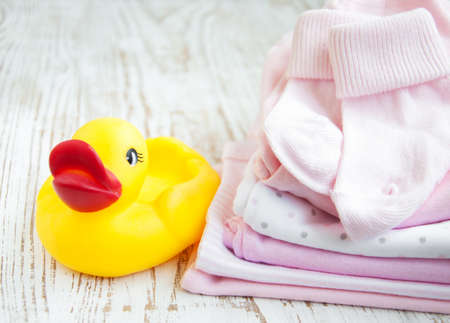 baby  pink apparel on a wooden backgroundの写真素材