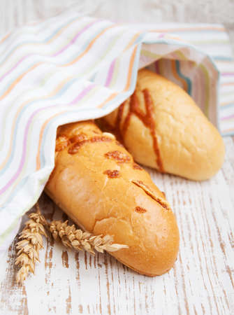 Bread and wheat corn over a old wooden background