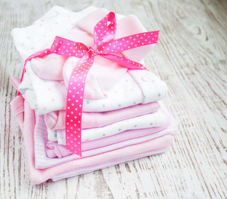 baby  pink apparel on a wooden backgroundの写真素材