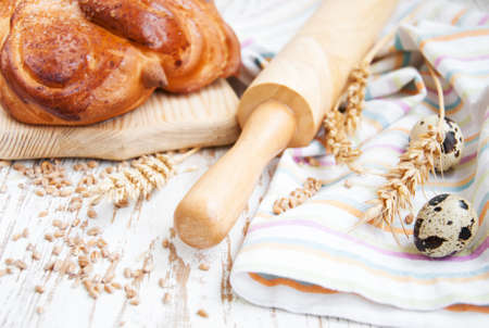 Bread and wheat corn over a old wooden background