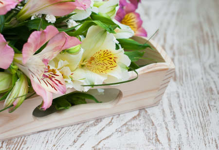 bouquet of a beautiful alstroemeria flowers on wood backgroundの写真素材