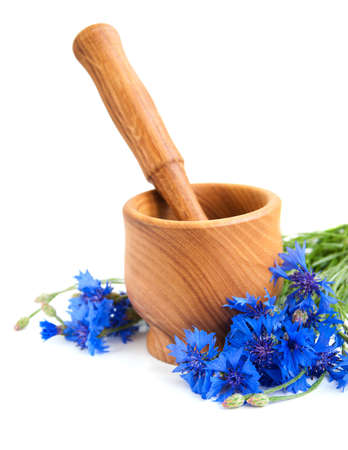 Mortar and pestle with cornflowers on a white backgroundの写真素材
